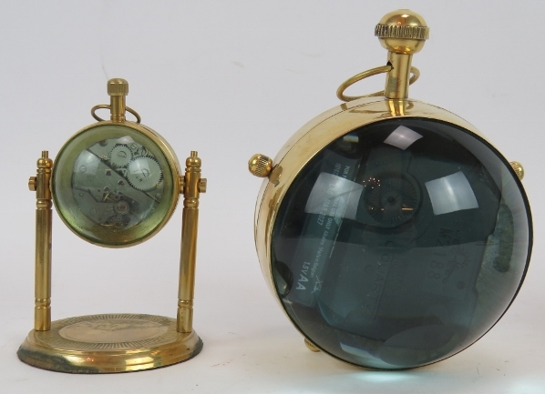 A brass cased orb quartz clock, a similar clock on stand and a German Europa alarm clock in a - Image 3 of 6