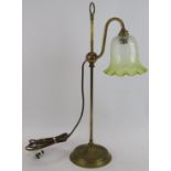 A brass rise and fall table lamp with etched green tinged shade. Max height 62cm. Condition