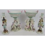 A pair of 19th century Dresden style porcelain chestnut baskets on figural mounts plus a pair of