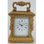 A small gilt brass 8 day French carriage clock in Empire Revival style by Elliott & Son, London.