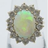 A gold, opal & diamond cluster ring, opal approx 12mm x 10mm, surrounded by 14 brilliant cut