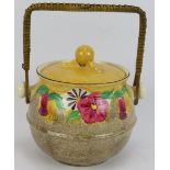 A Clarice Cliff Bizarre biscuit barrel, 335 shape, hand decorated with pansies and bell flowers.