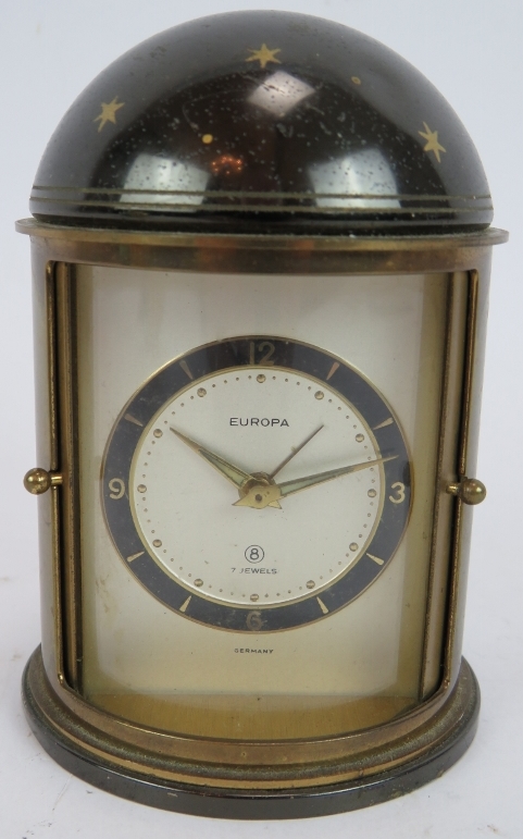 A brass cased orb quartz clock, a similar clock on stand and a German Europa alarm clock in a - Image 4 of 6