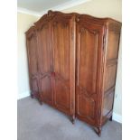 A very large 19th century style French oak armoire with shell and acanthus carved cornice, the
