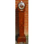 An English Art Deco walnut grandmother clock with silvered chapter and Roman numerals with chiming