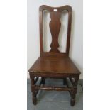 An 18th century oak occasional chair with shaped back splat, on turned and block supports with
