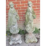A pair of nicely weathered reconstituted stone garden ornaments in the form of classical maidens
