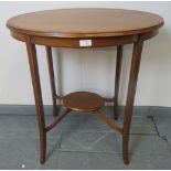An Edwardian mahogany oval two tier occasional table strung with satinwood. Condition report: No