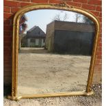 A large 19th century style giltwood framed arched overmantle mirror with applied cornice decoration