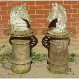 A pair of nicely weathered reconstituted stone horse head busts, mounted on cast iron roundels and