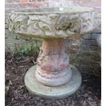 A large and impressive nicely weathered reconstituted stone planter on pedestal with relief moulding