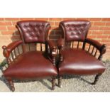 A pair of late Victorian mahogany open sided armchairs, upholstered in a deep grain buttoned brown
