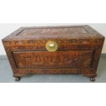 A vintage camphorwood Chinese coffer/blanket box with relief carved panels depicting sailing