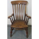 A 19th century elm and beech Windsor fireside chair, on turned supports with a waisted double ?H?