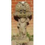 A nicely weathered reconstituted stone bird bath in the form of Cupid supporting a clam shell (a/f).