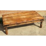 A tropical hardwood metal mounted Thakat coffee table, with trade label ?William Sheppee?, on turned