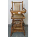 A turn of the century French beech metamorphic child?s high-chair by ?Le Reve?, with bergere seat