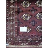 A Persian Turkman rug on brown ground. 1.48x1.05. Condition report: In good condition - slight