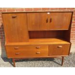 A mid-century teak highboard by G Plan, featuring a fall front drinks cabinet, two cupboards and two