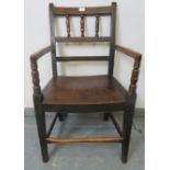 A 19th century country made oak elbow chair, with bobbin turned spindles, on tapering supports