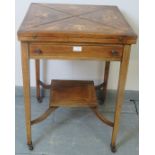 An Edwardian Regency revival rosewood envelope card table, featuring marquetry inlay and single