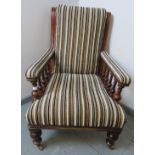 A Victorian mahogany library chair, reupholstered in a contemporary striped chenille material, on