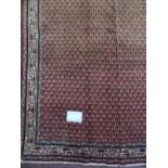 A good quality Araak rug with close repeat pattern on burnt amber ground. 2.03x1.40