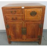 A Chinese Juzhou style jumu wood (southern elm) side cabinet of three short drawers over double