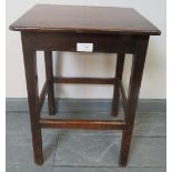 A 19th century country made oak stool, on square supports with stretchers. Condition report: Chip to
