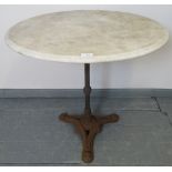 An antique circular garden table with white marble top, on a cast iron tapering reeded column with