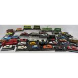 A collection of metal scale model cars, buses, trams etc, mostly mounted on plinths with