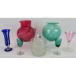 Six pieces of coloured glass including a controlled bubble vase, fluted cranberry jug, three glasses