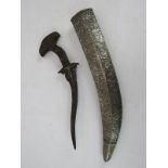 An antique Eastern Kris dagger with curved steel blade and an unassociated white metal repousse