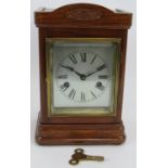 A 1920s oak cased mantel clock of small proportions with silvered dial and striking movement. Height