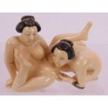 A finely carved erotic Japanese ivory Netsuke, early 2th century, featuring two females. Height: 3.