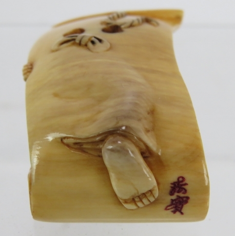 A finely carved Japanese ivory Netsuke, Meiji period, of a semi nude female on a scroll decorated in - Image 3 of 4