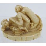 A Japanese carved ivory erotic Okimono, early 20th century, featuring a man and woman in erotic
