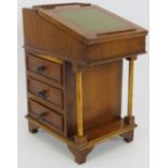 A miniature Davenport desk, probably an apprentice piece, with leather top, internal fittings and