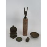 A bronze Indian temple oil lamp, a bronze weight, Sphinx on pink granite column, brass Chinese