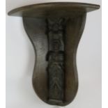 A large oak wall bracket corner shelf with earlier carved caryatid figure to centre. Height 62cm.