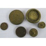 Six brass coins and trade weights including a James I gold crown Briot weight. a Portuguese 8 Escudo