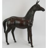 A large vintage leather horse with glass eyes, possibly by Liberty & Co. Height 71cm. Condition