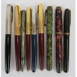 Seven vintage fountain pens including a red marbled Parker Duofold, a green marbled Duc, a