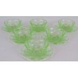 A vintage pressed uranium glass fruit set consisting of six bowls and six dishes each with etched