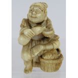 A finely carved Japanese ivory Netsuke, Meiji period of a fisherman sitting on a log. Height: 4.5cm,