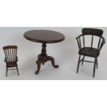 A miniature Georgian style mahogany tilt-top table, a miniature stick back arm chair marked D. Booth