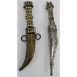 Two ornate Eastern daggers, one decorated with niello white metal, the other with a bejewelled