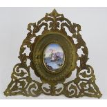 A mid 19th century folding picture frame in gilt metal with porcelain oval cartouche. Signed for