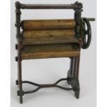 A miniature laundry mangle constructed from steel, brass and wood, fully working. Height 26cm.