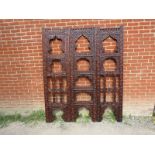 An Arts & Crafts hardwood three section folding screen, ornately carved in the manner of Liberty &